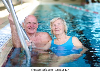 Happy Healthy Active Senior Couple Having Fun Together In The Swimming Pool 