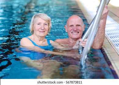 Happy Healthy Active Senior Couple Having Fun Together In The Swimming Pool