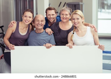 Happy Healthy People Behind Empty White Board While Inside the Fitness Gym. Emphasizing Copy Space for Texts. - Powered by Shutterstock