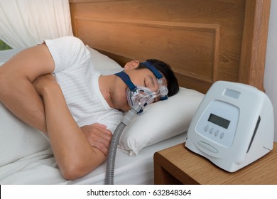 Happy And Healthy Senior Man Wearing Cpap Mask Sleeping Smoothly All Night Long On His Left Side With Cross Arms Without Snoring, High Angle View.Obstructive Sleep Apnea Therapy.

