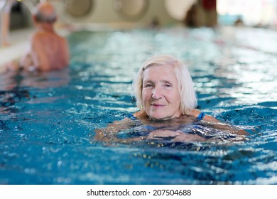 Happy Healthy Senior Woman Enjoying Active Lifestyle Swimming In The Pool