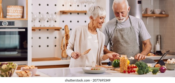 happy and healthy seniors prepare vegan food at home - Powered by Shutterstock