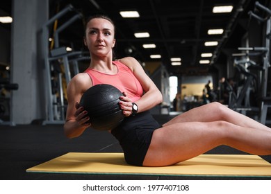 Happy Healthy Strong Woman Doing Russian Twist Abs Workout With Medicine Ball At The Gym