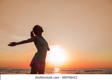 Happy And Healthy Woman Standing In Sunset 