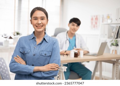 Happy healthy young  asian woman patient visiting old male doctor, portrait. - Shutterstock ID 2365777047