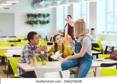 Happy High School Students Taking Lunch Together At School Cafeteria