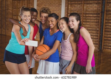 Happy high school team taking a selfie with mobile phone in the court - Powered by Shutterstock