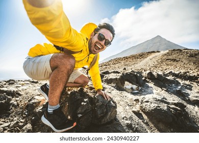 Happy hiker having fun hiking mountains - Active young man taking selfie pic with smart mobile phone device outdoors - Action cam, extreme sports and summertime holidays concept - Powered by Shutterstock