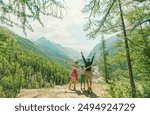 Happy hikers family in the wild mountains 