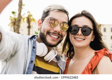 Happy Hipster Couple Taking Selfie During Travel Summer Vacation Outdoor In The City - Fun Traveler People - Focus On Faces