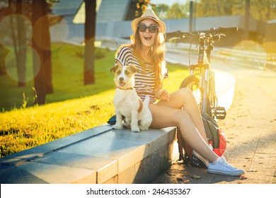 Happy Hipster Girl With Her Dog And Bike In The City. Toned And Filtered Photo. Modern Youth Lifestyle Concept.