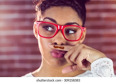 Happy Hipster Wearing A Fake Mustache On Her Finger