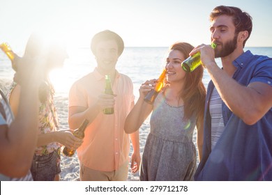 Happy Hipsters Drinking Beer At The Beach