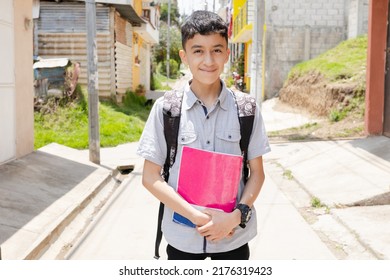 Happy Hispanic boy ready to go to school with his backpack and notebooks - Latin boy on his way to school - Happy boy in town