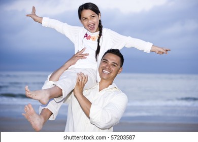 Happy Hispanic Dad And 9 Year Old Daughter Having Fun On Beach