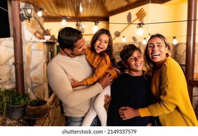 Happy Hispanic Family Enjoying Time Together At Home