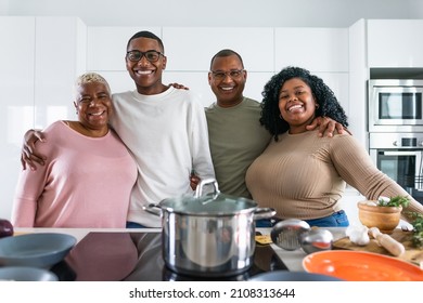 Happy Hispanic Family Having Fun Cooking Together In Modern Kitchen - Food And Parents Unity Concept