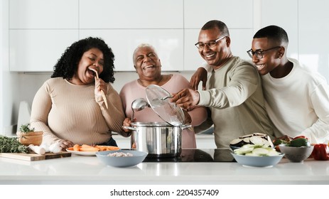 Happy Hispanic family having fun cooking together in modern kitchen - Food and parents unity concept - Shutterstock ID 2204357409