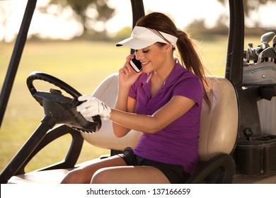 Happy Hispanic female golfer talking on the phone while driving a golf cart