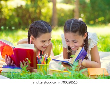 Happy Hispanic Girls Drawing And Studying In Summer Park