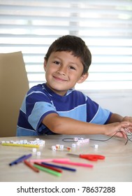 Happy Hispanic Or Latino Boy Playing At Crafts