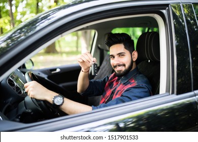 Happy Hispanic Man Showing The Key Of His New Car