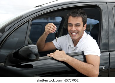 Happy Hispanic Man Showing The Key Of His New Car