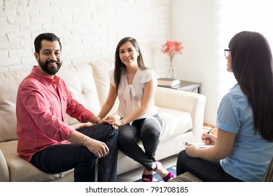 Happy Hispanic Married Couple Visiting Psychologist For Counseling