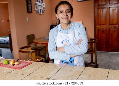 Happy Hispanic Mom In Her Kitchen - Proud Housewife At Home - Young Mother With Apron In The Kitchen