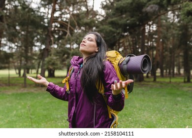 Happy Hispanic Senior Hiker Taking In Backpacking Mountain, Doing Trekking