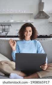 Happy Hispanic Teen Girl Waving Using Laptop Computer Enjoying Online Virtual Chat Video Call With Friends Or Family In Distance E Chat Virtual Meeting Using Pad Computer Sitting On Sofa At Home.