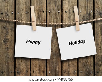 Happy holiday of note paper with wood clip on wood background design. - Shutterstock ID 444988756