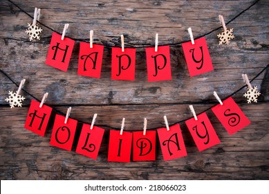 Happy Holidays Greetings on red Tags Hanging on a Line with Snowflakes, Christmas or Winter Background - Shutterstock ID 218066023