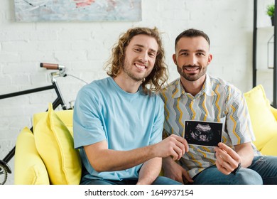 Happy Homosexual Men Holding Ultrasound Scan