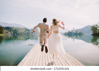 happy honeymoon couple travel europe, Slovenia. Wedding couple happy jump and travel Slovenia, Lake Bled.