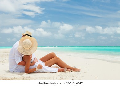 Happy honeymoon vacation at Paradise. Couple relax on the white sand of beach. Happy sea lifestyle. Young family, man and woman rest on the beach of ocean. Couple in love travel to island. Love travel