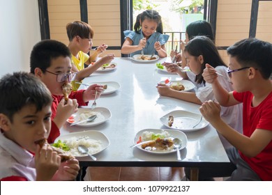 Happy Hour Of Children Eating Together,elementary Pupils Eating At The Canteen At School. Social Participation And Joint Activities Of Children,health,education Concept