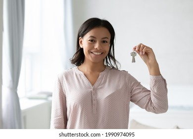 Happy House Buyer Or New Home Owner Celebrating Property Purchase. Real Estate Broker Or Agent Holding Key From Apartment For Sale Or Rent. Consultant Offering Help With Mortgage. Headshot Portrait