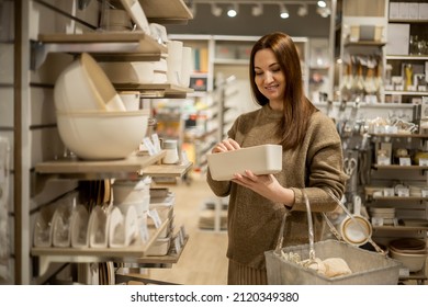 Happy Housewife Choosing Eco Friendly Ceramic Case With Wooden Lid For Food Storage Comfortable Placing In Kitchen Cupboard. Smiling Female With Box Container Enjoying Shopping At Household Store