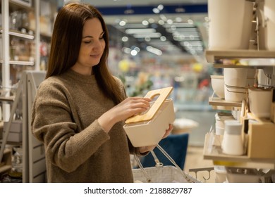 Happy Housewife Choosing Eco Friendly Ceramic Case With Wooden Lid For Food Storage Comfortable Placing In Kitchen Cupboard. Smiling Female With Box Container Enjoying Shopping At Household Store