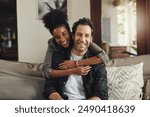 Happy, hug and couple with portrait on sofa for weekend bonding, interracial and romance together. Man, smile and woman with affection at home on couch for connection, love and support in marriage