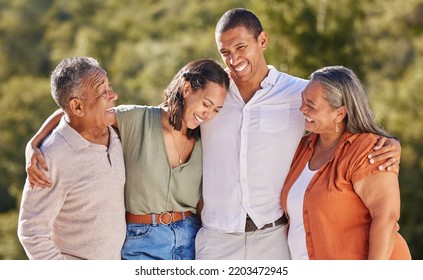 Happy, hug and smile, an adult family in a park standing together. Mother, father grown up kids laughing. Happiness, love and nature, man and woman with senior couple in nature at an outdoor event. - Shutterstock ID 2203472945