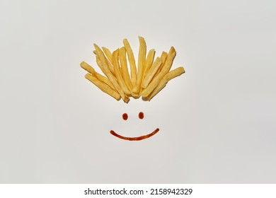Happy Human Face Smile From Tomato Or Pepper Sauce And French Fries Isolated On White Background. Unhealthy Eating And Fast Food. Fresh Tasty And Appetizing Snack For Leisure. Studio Shoot. Copy Space