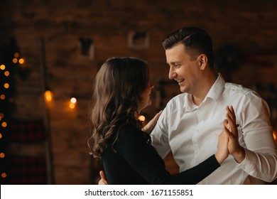 happy husband and wife are dancing in the studio - Shutterstock ID 1671155851