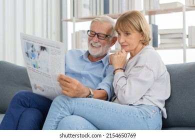 Happy husband and wife senior couple elderly family, caucasians mature, adult lover and retired man, woman reading newspaper,  report on sofa together at home. Husband and wife lifestyle. - Powered by Shutterstock