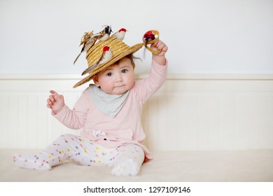 Happy image of baby girl smiling on bed wearing summer outfit 