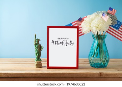 Happy Independence Day, 4th Of July Celebration Concept With Photo Frame Mock Up, Home Decor And USA Flag On Wooden Table