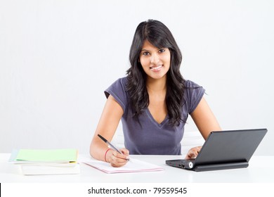 happy indian college student studying - Powered by Shutterstock