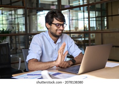 Happy Indian Corporate Manager Coach Waving Leading Virtual Business Training, Remote Work Meeting Conference Online Video Call. Company Leader Having Distant Videoconference Interview On Laptop.