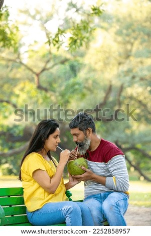 Man holding hot dog in barbecue with friends